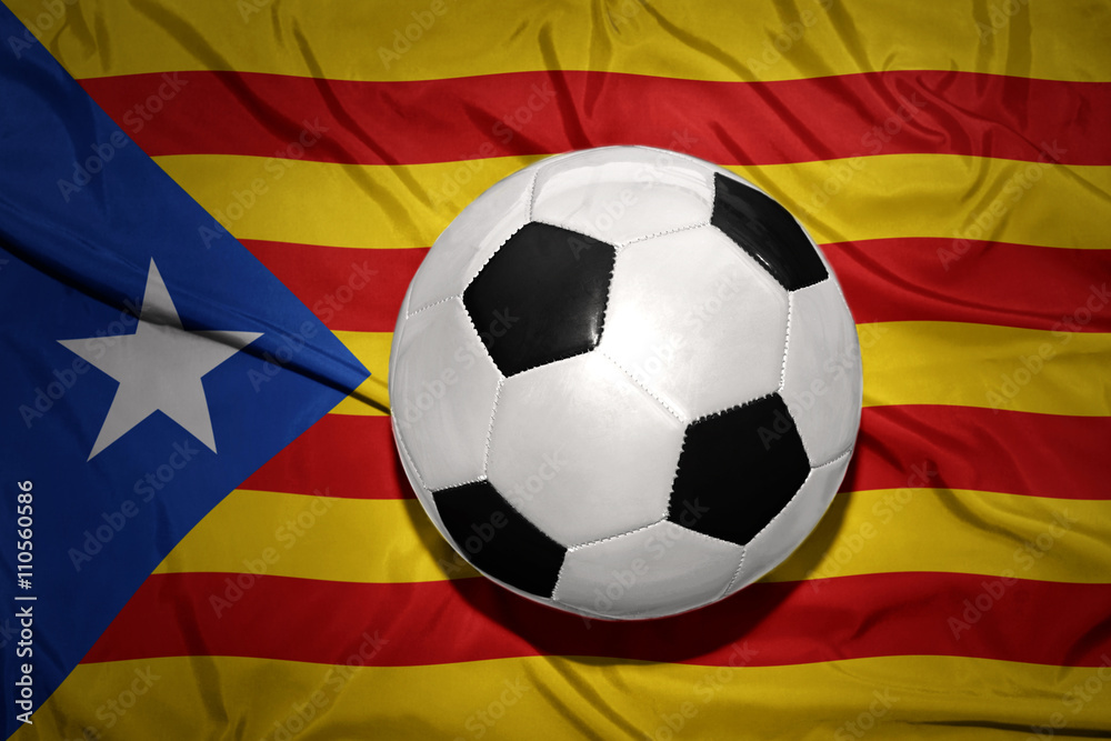Naklejka premium black and white football ball on the national flag of catalonia