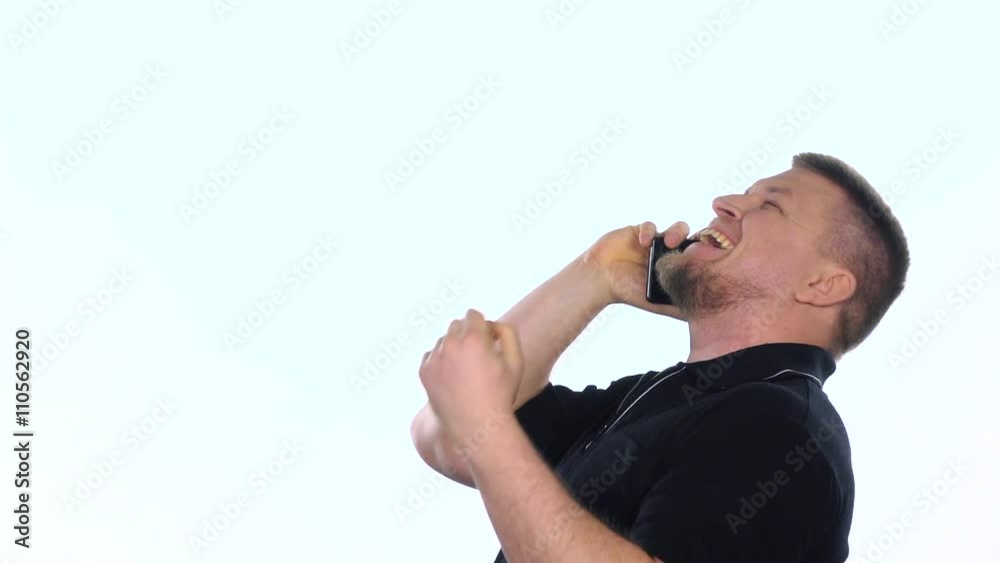 Talking on the phone. Guy laughs. White. Sow motion Talking on the phone. Guy laughs. White. Sow motion