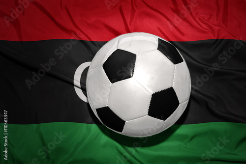 black and white football ball on the national flag of libya