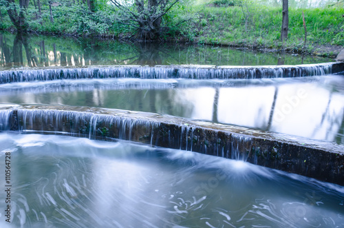 small waterfall on a small picturesque brook in the forest