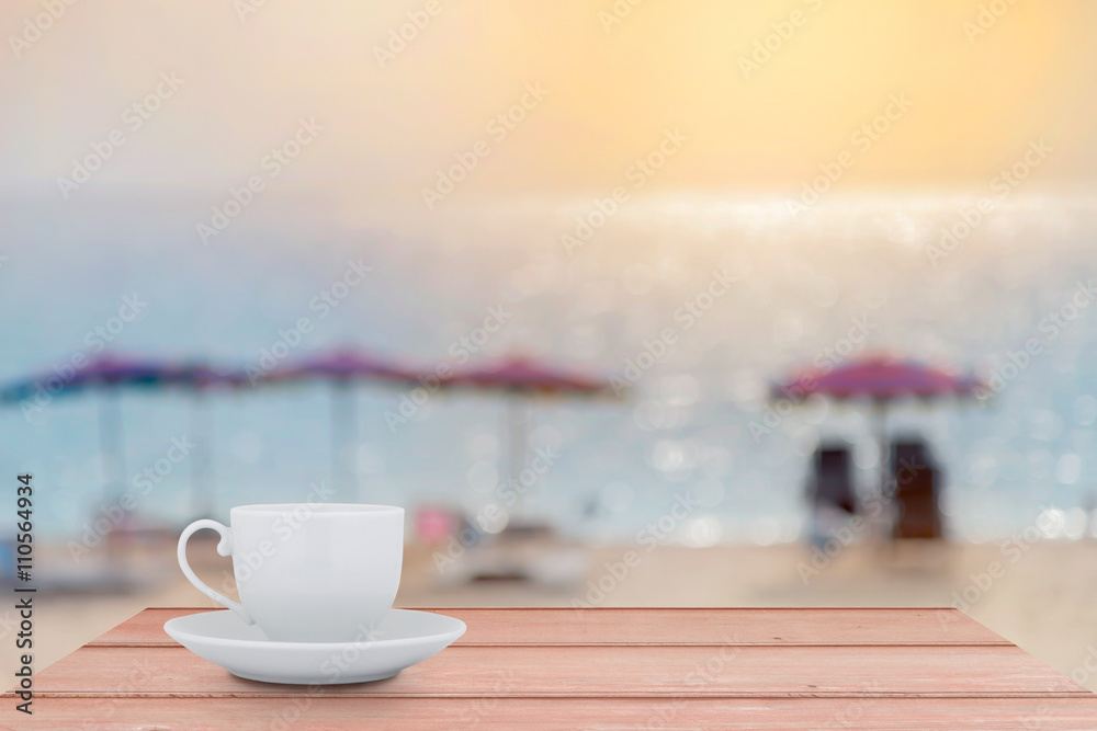 White Coffee cup on the wood table with blur scenery sea beach b