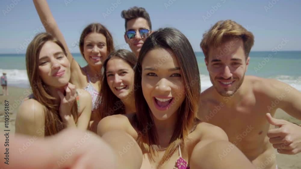 Head and Shoulders Group Portrait of Young Adult Friends Wearing Swim Suits and Having Fun on Sunny Beach with View of Ocean in Background Head and Shoulders Group Portrait of Young Adult Friends Wearing Swim Suits and Having Fun on Sunny Beach with View of Ocean in Background