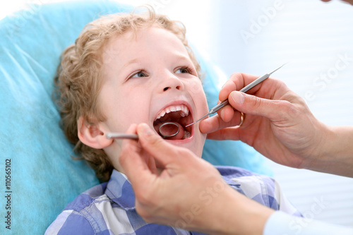 Close up of boy having his teeth examined by a dentist