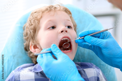 Close up of boy having his teeth examined by a dentist