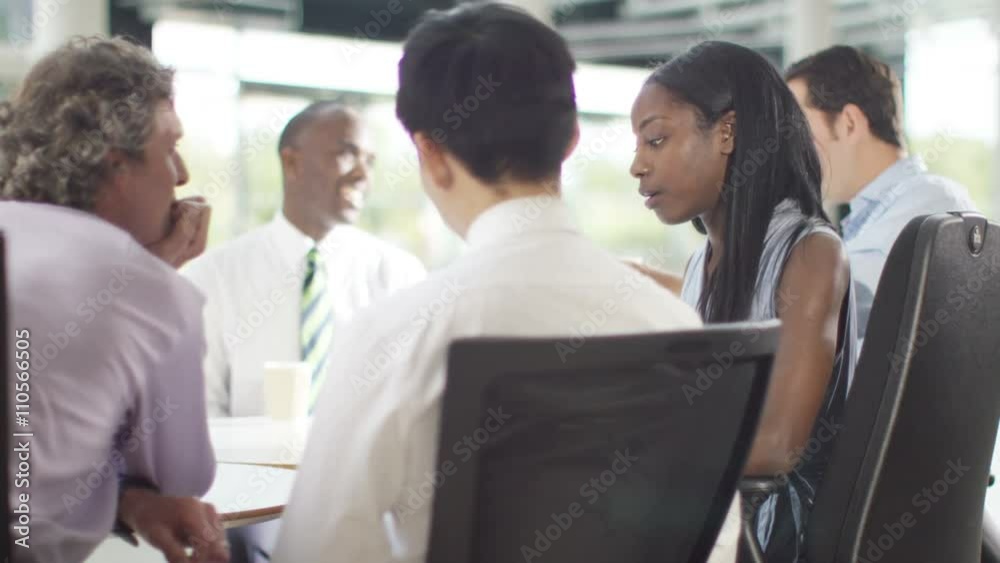 Attractive mixed ethnicity business group discuss ideas in office meeting Attractive mixed ethnicity business group discuss ideas in office meeting