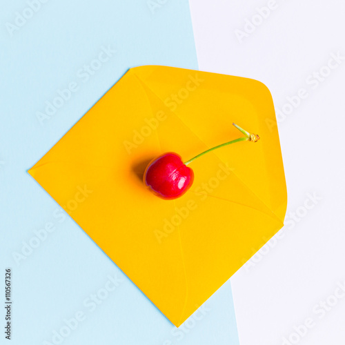  an isolated cherry on envelope, in a contemporarypastel color background