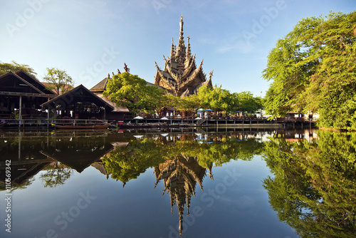 Sanctuary of truth and park in Pattaya reflecting in water photo