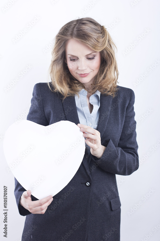 Beautiful business woman with a white heart in the hands. Banner in the form of heart. Beautiful blonde
Beautiful business woman with a white heart in the hands. Banner in the form of heart. Beautiful blonde