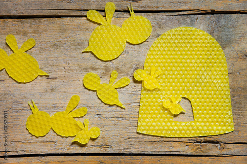 beeswax, bees and a beehive on wooden table photo