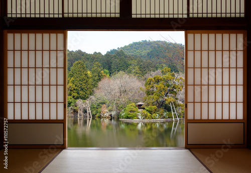 View of a beautiful oriental pond seen through open Japanese sliding doors photo