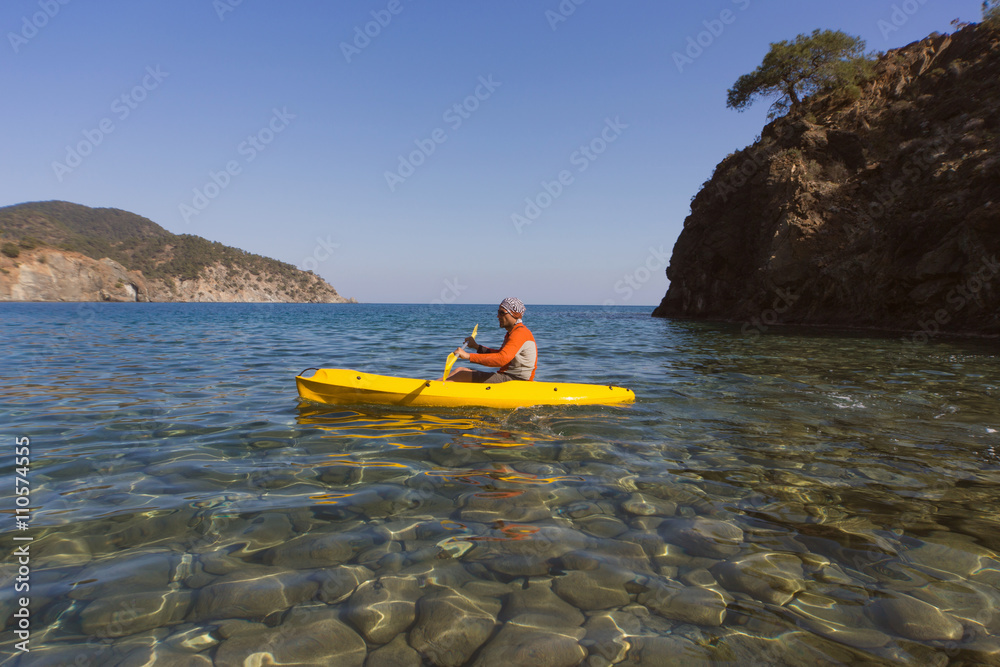 Fototapeta premium Men travel by canoe on the sea in the summer. 