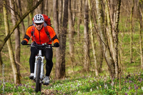 Cyclist Riding the Bike on a Trail in Summer Forest