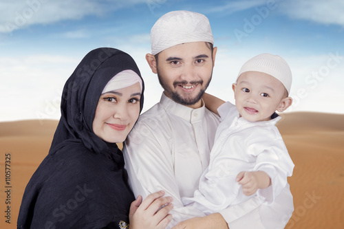 Arabic muslim family smiling at the camera