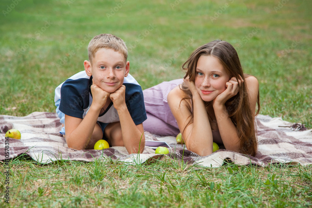 brother and sister resting in the garden. brother and sister resting in the garden.