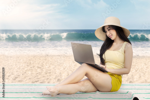 Woman working with laptop on the mat