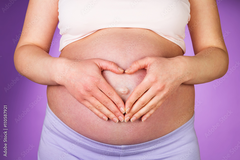 Heart from hands on belly pregnant Heart from hands on belly pregnant