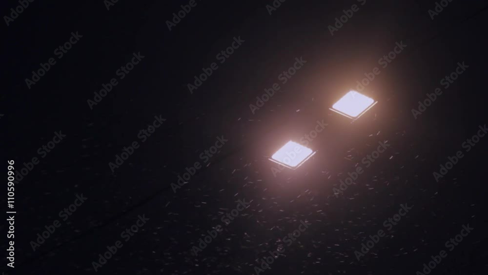 Night snow on the road lantern. Closeup shot. Night snow on the road lantern. Closeup shot.
