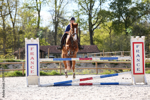 horsewoman training to jump before competition