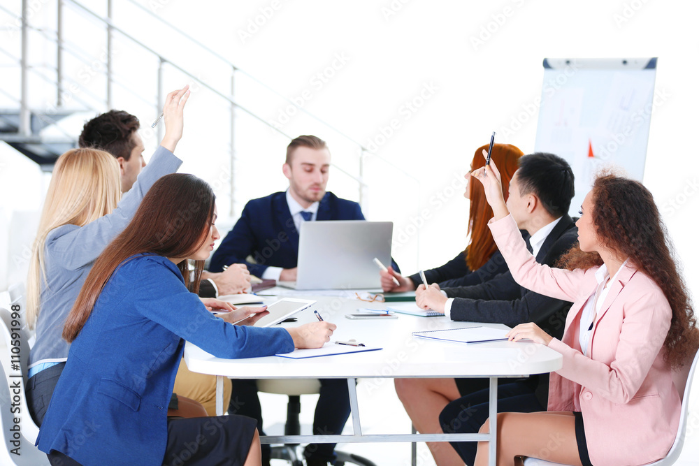 Young colleagues sitting at the business meeting in the office Young colleagues sitting at the business meeting in the office