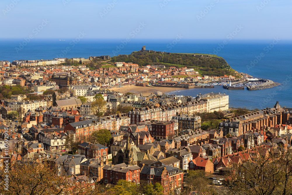 Scarborough town, beach and harbour. Viewed from Oliver's Mount. In Scarborough, England. On 5th May 2016.
