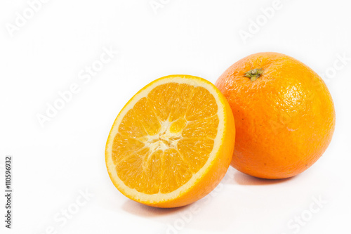 Sliced orange fruit with leaves isolated on white background