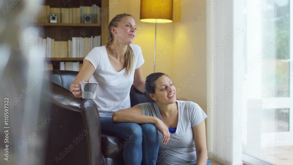 Attractive young gay couple relaxing at home and chatting Attractive young gay couple relaxing at home and chatting
