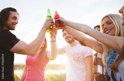 Group of young people cheering, having fun outdoors