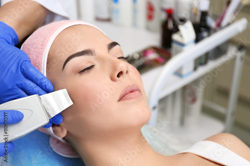 Young woman having face pro...
