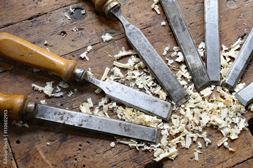 many sharp steel blades many chisels and sawdust chippings in Wo many sharp steel blades many chisels and sawdust chippings in Wo