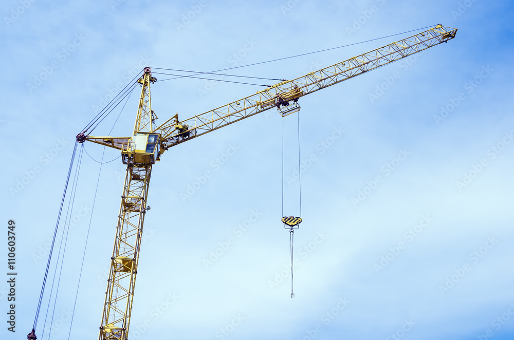 Tower crane on the sky background