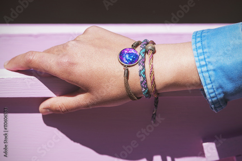 Stylish bracelets on female hand - top view