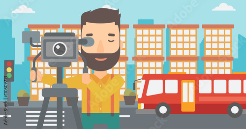 Cameraman with movie camera on a tripod.