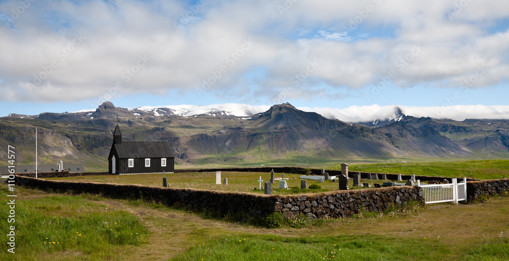 Icelandic black wooden church and cemetery