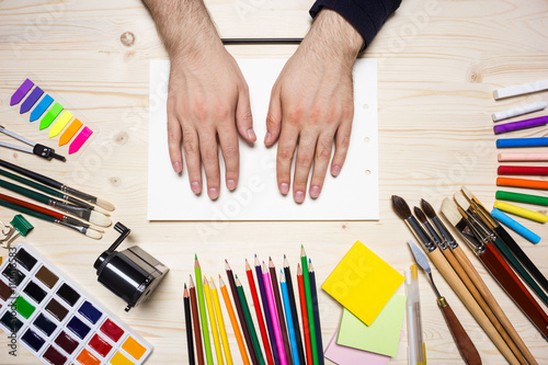 Man's hands and drawing tools