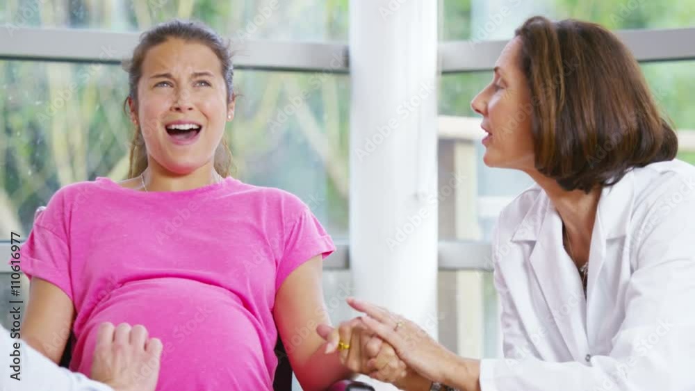 Pregnant woman going into labour concentrates on her breathing Pregnant woman going into labour concentrates on her breathing