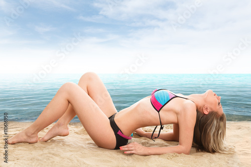 Sexy woman lying on sand