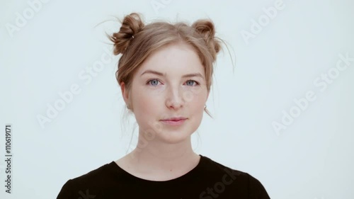 Smiling girl winking. Close up. 