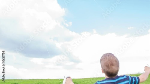 Boy with colorful kite on the green hill