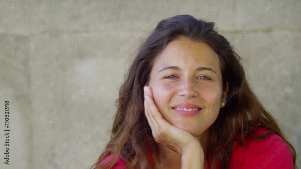 Candid portrait of beautiful woman smiling to camera outdoors in the city Candid portrait of beautiful woman smiling to camera outdoors in the city
