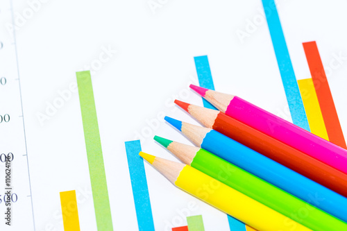 Colorful business charts and wooden pencils