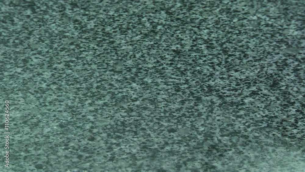 Granite processing in manufacturing. Polishing granite plate on the machine Granite processing in manufacturing. Polishing granite plate on the machine