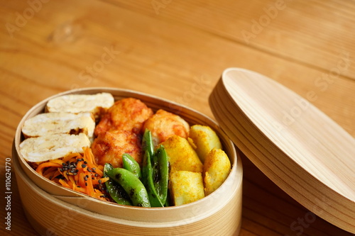 Home cooked healthy Bento lunch box with fresh vegetables and organic meals photo