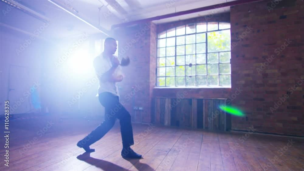 Asian martial artist training alone, practising moves with shaolin whip chain Asian martial artist training alone, practising moves with shaolin whip chain