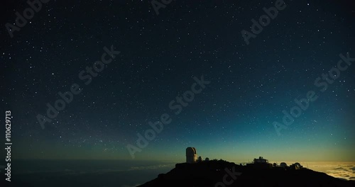 Star time lapse, milky way galaxy moving across the night sky above observatory