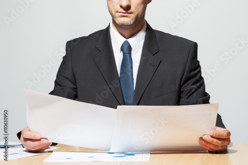 Businessman comparing two documents
