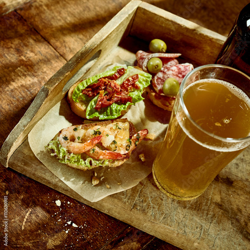 Delicious shrimp and veggetable tapas snack with beer photo