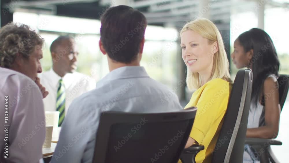 Attractive mixed ethnicity business group discuss ideas in office meeting Attractive mixed ethnicity business group discuss ideas in office meeting