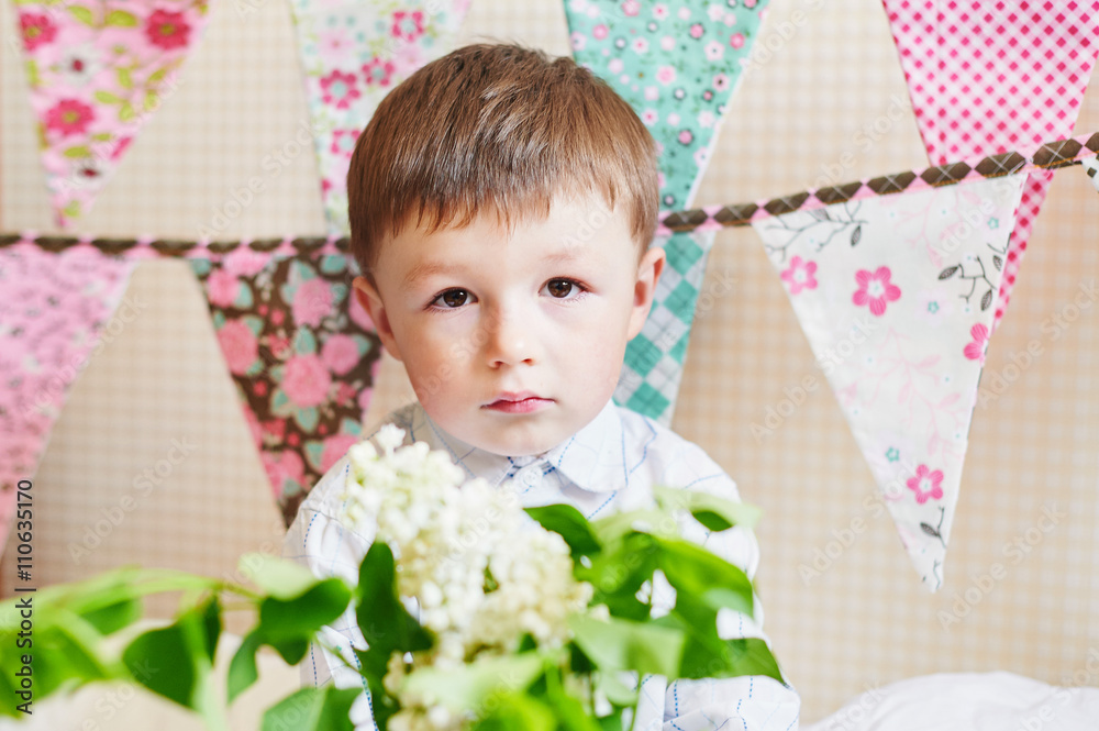 little boy with colorful flags on the background little boy with colorful flags on the background
