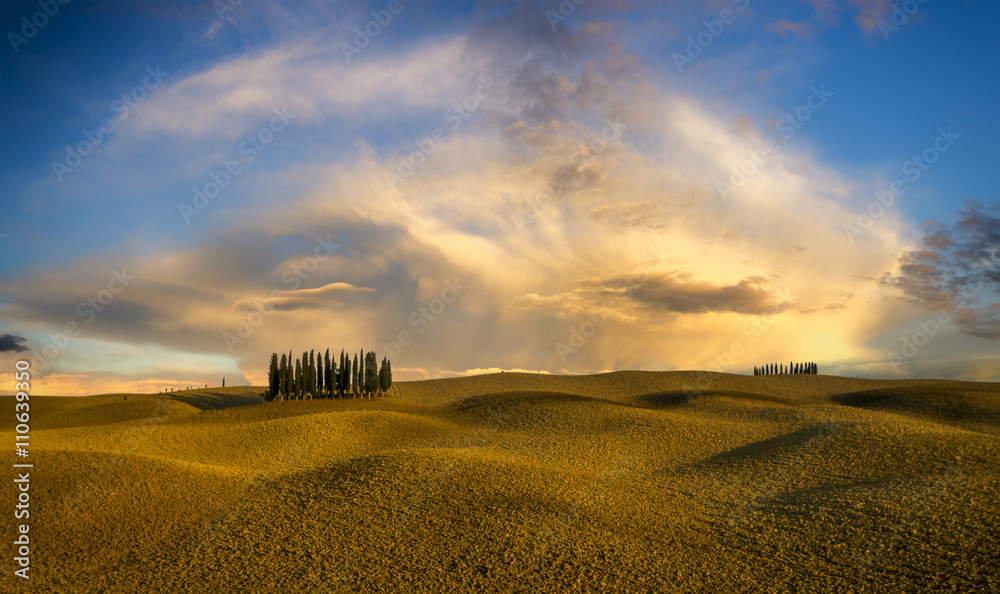 Fototapeta premium Burzowe chmury wieczornej burzy nad polem cyprysów w Toskanii