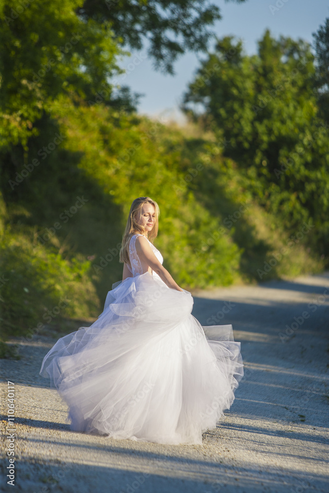 dancing bride on the road. Summer wedding photography.